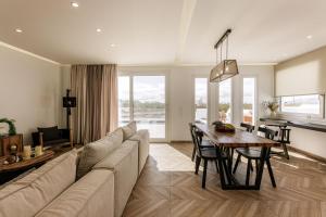 a living room with a couch and a table at Hidden Gem - 2Br Sea View Villas - Plaka Beach Naxos in Naxos Chora