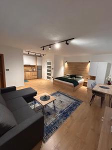 a living room with a couch and a bed at Apartmani Stars in Sarajevo