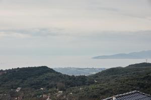 a view of a city and a body of water at TERPOU StoneHouse and Suites "StoneHouse" in Áyios Vlásios