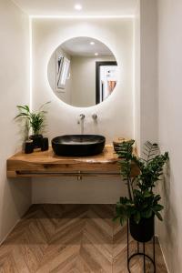 a bathroom with a black sink and a mirror at Hidden Gem - 2Br Sea View Villas - Plaka Beach Naxos in Naxos Chora