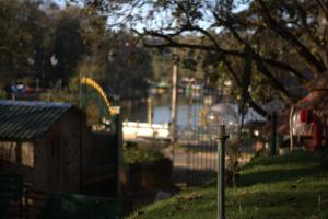 a parking meter in the grass next to a fence at The Tredis Heritage by the Lake in Kodaikānāl