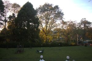 a park with a bunch of playground equipment in the grass at The Tredis Heritage by the Lake in Kodaikānāl