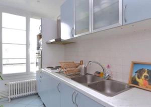 a kitchen with a sink and a counter top at Chambre chez l'habitant dans un appartement à 2 pas de la gare SNCF et à 300m de la gare routière in Creil +21 photos