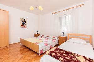 Postel nebo postele na pokoji v ubytování Apartments Marija 1921