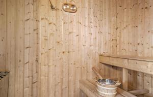 a wooden room with a bucket on a wooden wall at Stunning Home In Børkop With Sauna in Børkop +15 photos