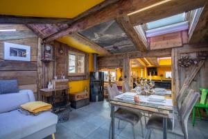 a dining room with a table and a kitchen at Chalet Schtuba in Zermatt