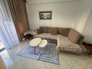 a living room with a couch and a table at Comfort Apartments Promenade in Sarandë