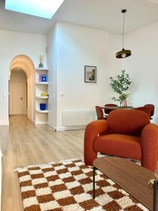 a living room with a couch and a table at L Arcade Chic & Confort - Terrasse - 5 min Gare in Amiens