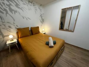 Un dormitorio con una cama grande con espejo. en Le tropical - hyper centre - patio - wifi, en Niort