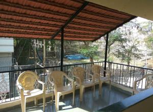 a group of chairs sitting on a balcony at Gurucharan in Shirdi
