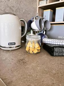 a kitchen counter with a toaster and a jar of food at Luxury 2 bedroom holiday home with stunning views in St. Andrews