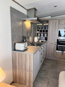 a kitchen with a counter with a toaster on it at Luxury 2 bedroom holiday home with stunning views in St. Andrews +24 photos
