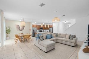 a living room with a couch and a dining room at SUPER BOHO 25 - 9BDR-7BAs SLEEP 22 wAMENITIEs in Kissimmee