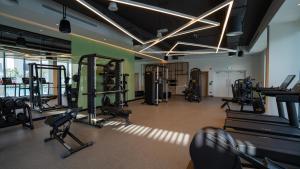 a gym with several treadmills and exercise equipment at Luxury Villa In Yas in Abu Dhabi