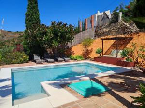 a large swimming pool in a yard with at Casa14 in Frigiliana