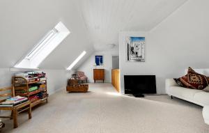 a living room with a couch and a tv at 5 Bedroom Beautiful Home In Gilleleje in Gilleleje +23 photos