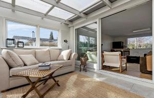 a living room with a couch and a table at 5 Bedroom Beautiful Home In Gilleleje in Gilleleje
