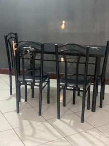 a black table with two black chairs around it at Mila home in Arusha