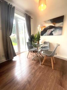 a dining room with a table and chairs and a window at The Billingham House By Blue Skies Stays in Stockton-on-Tees