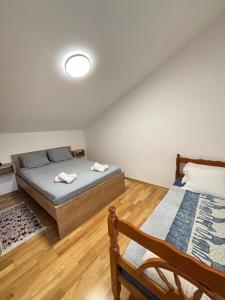 a bedroom with two beds in a room at Aerodrom Appartment ''Ana'' in Tivat