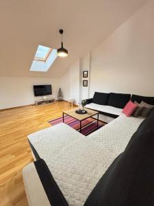 a living room with a couch and a table at Aerodrom Appartment ''Ana'' in Tivat
