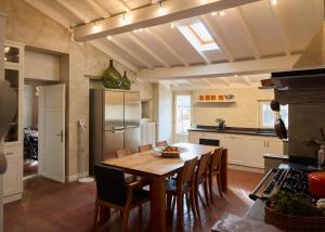 a kitchen with a wooden table and chairs in a room at Terrazza - A Bella Vista Apartment - Luxury in Lucca Centro in Lucca