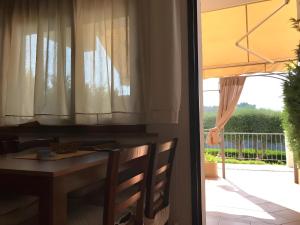 a dining room table with a view of a balcony at Villa Del Conte in Drapia
