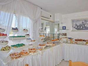 a white table with many baskets of food on it at Residence & Bed e Breakfast AlaMarina in Peschici