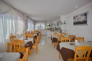 a dining room with tables and chairs and a unintention at Residence & Bed e Breakfast AlaMarina in Peschici
