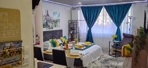 a room with a bed and a table in a room at Blue Shades Studio in Hunedoara