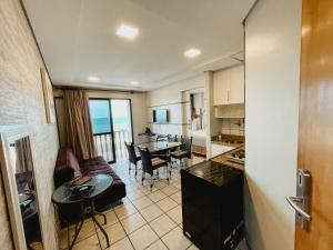 a kitchen and a living room with a couch and a table at Classic Residence in Fortaleza +22 photos