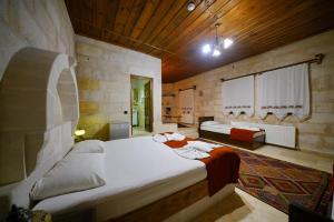 a large bedroom with two beds in a room at Glory Art Stone House in Göreme