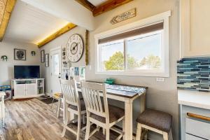 a kitchen and dining room with a table and chairs at The Sandbox at Rockaway Beach in Rockaway Beach