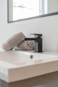 a bathroom sink with a towel laying on it at Le Raffine hot tub River Front in Saint Come +39 photos