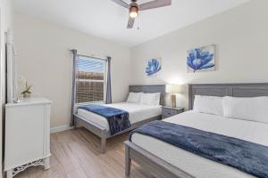 a bedroom with two beds and a window at Ground Floor Beach Side 2Min Walk To The Beach SF in South Padre Island +20 photos