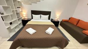 a bedroom with a large bed and a couch at EVEREST Готель in Poltava +49 photos
