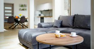 a living room with a couch and a table with donuts on it at Apartment Step-Free in Świeradów-Zdrój