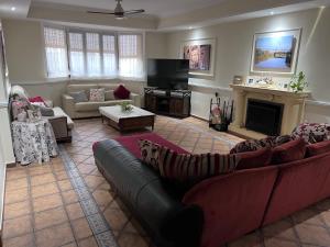 a living room with a couch and a fireplace at El Carmen in Córdoba