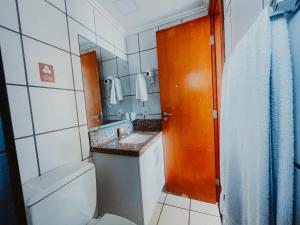 a small bathroom with a sink and a mirror at Classic Residence in Fortaleza +28 photos