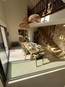 una sala da pranzo con un lungo tavolo e sedie di Villa Julorian proche Saint Emilion au cœur des vignobles a Sainte-Colombe