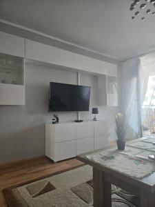a living room with a flat screen tv on a wall at Apartament Grabskiego in Gorzów Wielkopolski