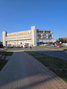 a building with a person walking in front of it at Apartament Grabskiego in Gorzów Wielkopolski