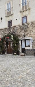 a building with a christmas tree in front of it at Casa Al Colle in Pescocostanzo