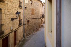 an alley in an old stone building with a street light at Loft El Roure, El Vilosell in El Vilosell