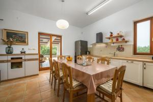 a kitchen with a table and chairs in a room at Holiday house Lera Rovinj, with football field, sauna, jacuzzi in Rovinj +43 photos