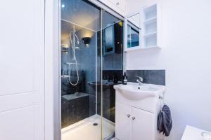 a bathroom with a shower and a sink at The Knutsford Townhouse by Staycay in Knutsford