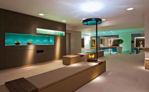 a living room with a fish tank in the wall at Porto Platanias Beach Resort & Spa in Plataniás