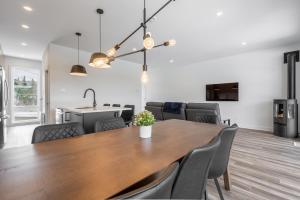 a dining room with a wooden table and chairs at Le Raffine hot tub River Front in Saint Come
