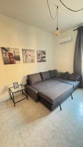 a living room with a couch and a table at Holidayhouse in Civitavecchia