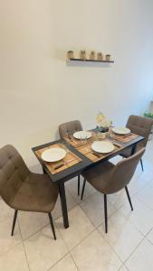 a dining room table with chairs and a table and chairsktop at Holidayhouse in Civitavecchia +3 photos